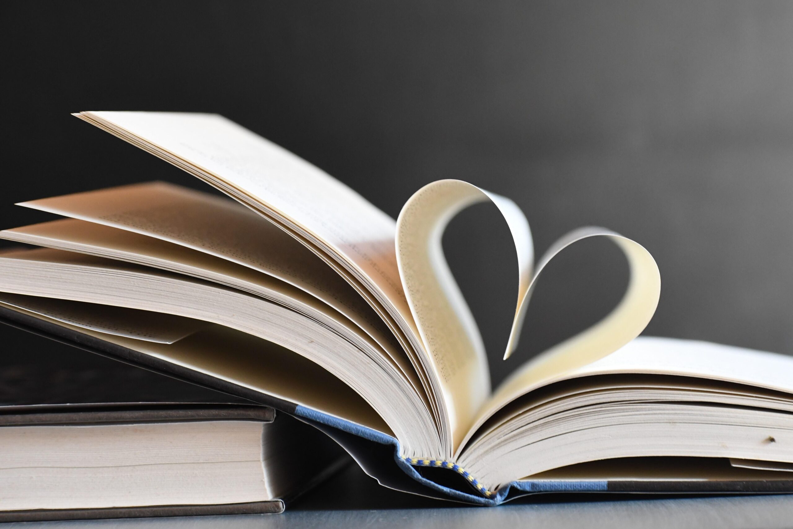 Open book with pages forming a heart, symbolizing love for reading and literature.